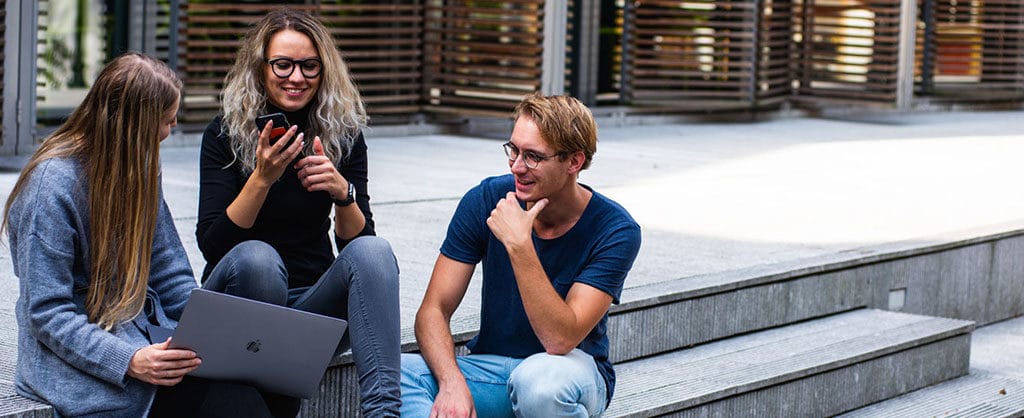 Students looking at a laptop as part of their international travel experience